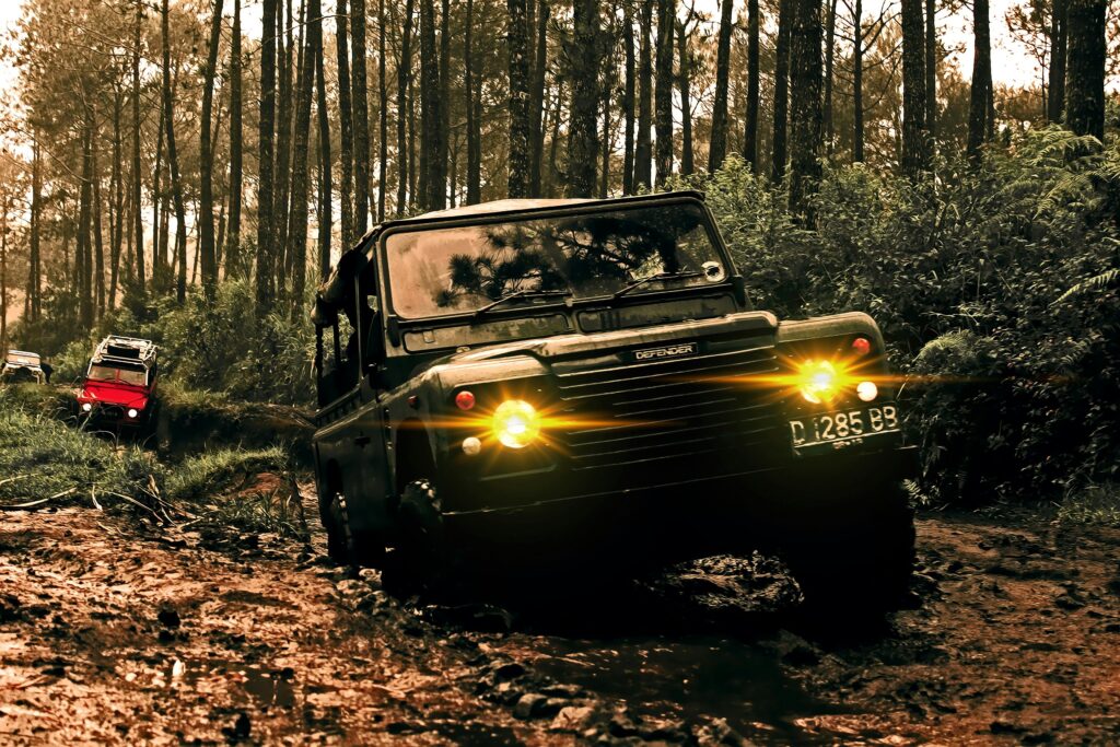pexels-photo-761815-761815 Rugged SUVs navigate muddy terrain in Parongpong, Indonesia forest.